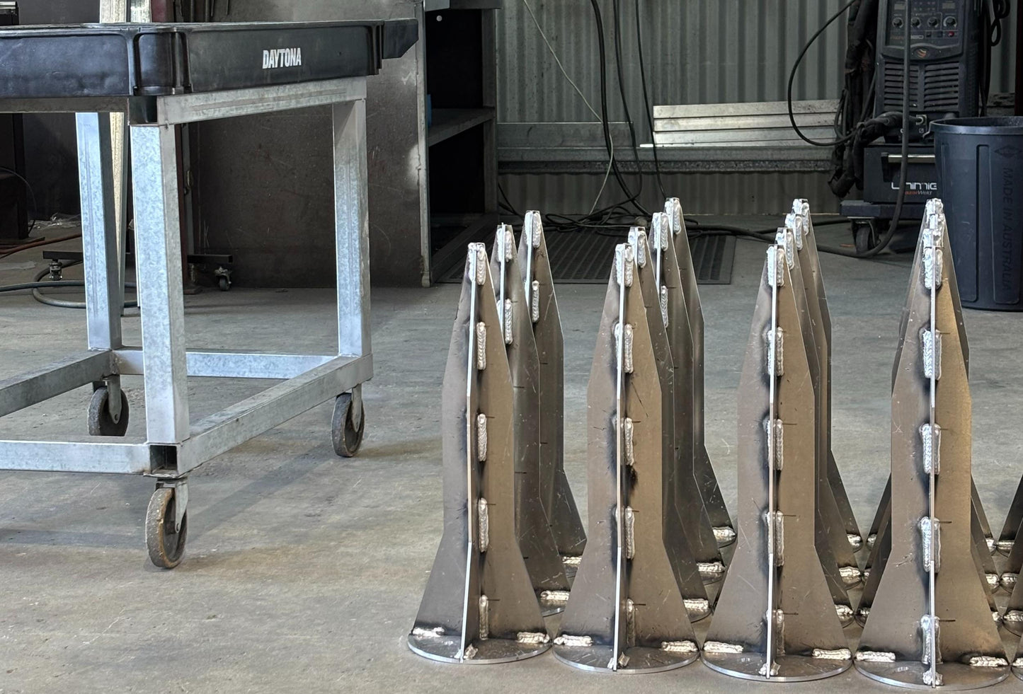 Set of galvanized metal ground anchors with flat feet and mounting hardware