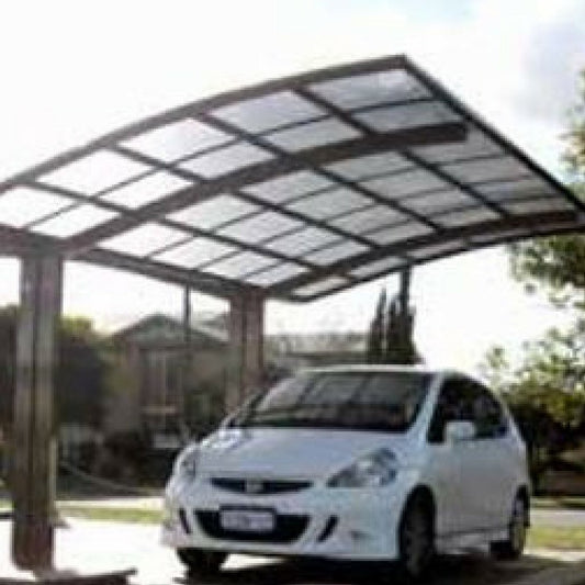 Cantilever carport with dark roof panels over a parked silver car