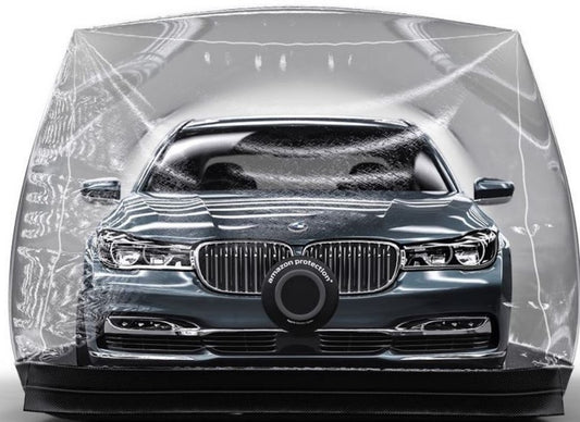 Inflatable car cover over dark sedan, grille close-up with clear bubble-like wrap